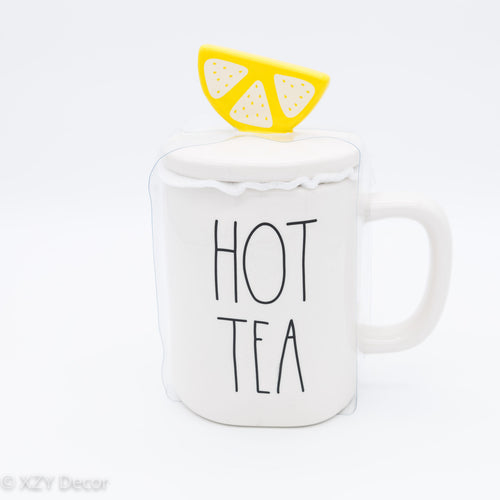 White Mug with words “Hot Tea” on the side and a lemon topper by artisan designer Rae Dunn.